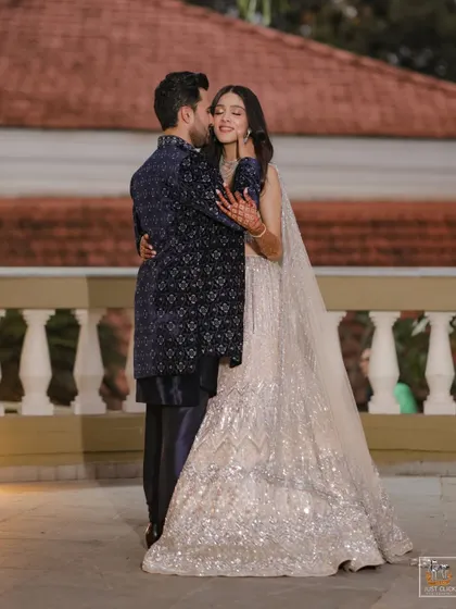 An elegant portrait of the couple on a balcony during their Sangeet in Goa.