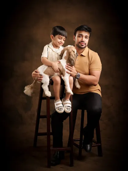 Pets are family, and we love including them in our sessions. This painterly portrait of a father, son, and their beloved dog against a classic brown backdrop creates a warm, classic image that feels like a treasured family painting.