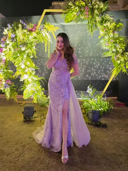 A full-length view of my sparkling gown against a beautiful floral backdrop. The right outfit makes you feel confident and ready to take on the stage.