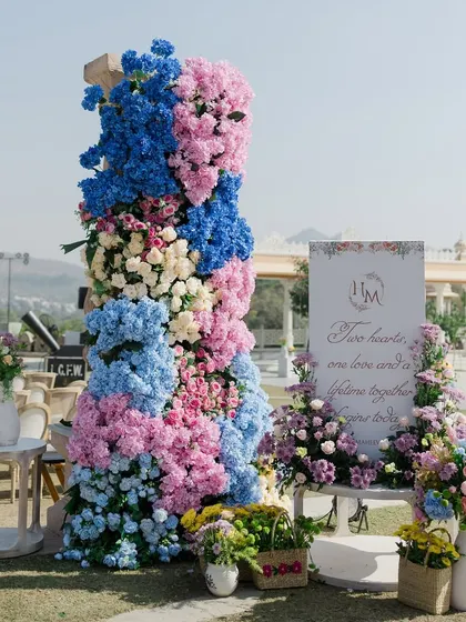 The welcome signage and floral arrangement that greeted guests. The design introduces the pastel color palette and elegant floral theme of the wedding from the very first moment.