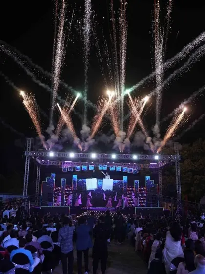 The view from the audience of a massive Sangeet production. The combination of a huge stage, lighting, and pyrotechnics creates an immersive concert-like experience for all the guests.