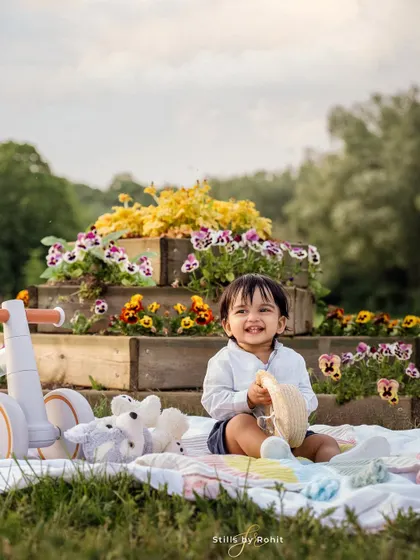 A perfect little picnic for a perfect first birthday! This happy baby is surrounded by his favorite toys and beautiful flowers, creating a sweet and memorable scene.