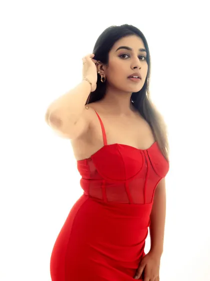 A thoughtful, looking-away pose in the red dress. This adds a touch of storytelling and emotion to the fashion series.