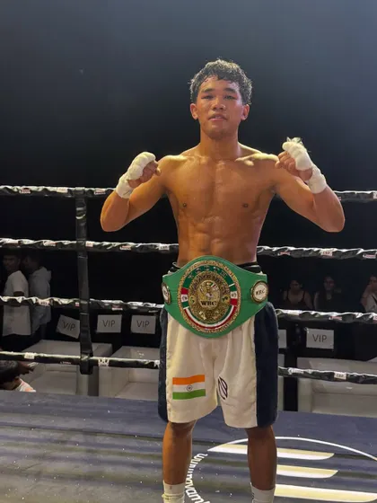 The physique of a champion. Laldinsanga, shredded and victorious, with the belt he fought so hard for.