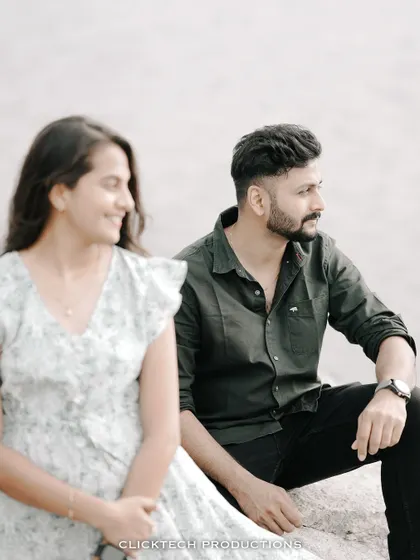 A creative shot using depth of field, with the groom in focus and the bride smiling in the blurred foreground.