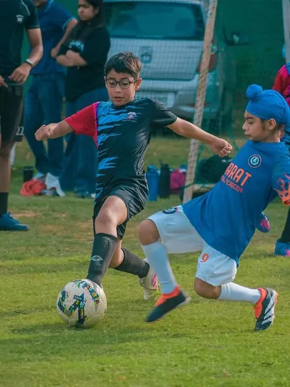 A young player in a turban showing incredible determination. My tournaments are for everyone, celebrating diversity and a shared passion for football.