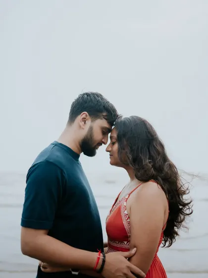 An intimate close-up of a couple with their foreheads touching, captured during their pre-wedding shoot at the beach.
