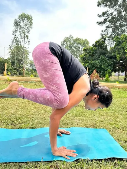 The focus and determination of a student holding Bakasana (Crow Pose) during our yoga retreat. Practicing outdoors challenges your balance and brings a new level of awareness to your asana.
