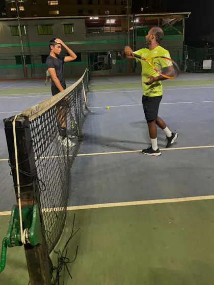Demonstrating the correct racket path for a volley. We focus on teaching the finer points of the game to give our players an edge.