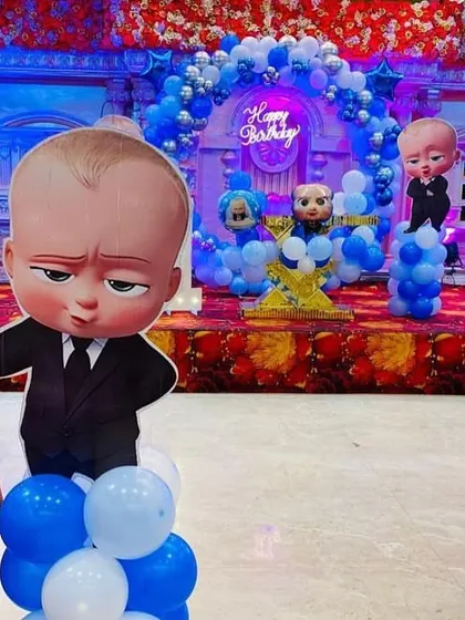 A view of the party space showing multiple 'Boss Baby' cutouts placed around the room to enhance the theme.