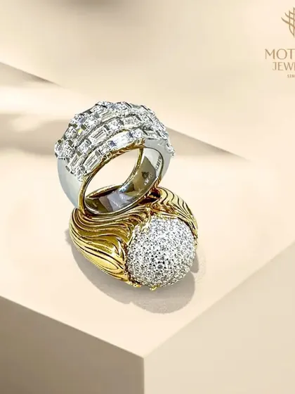 A duo of powerful statement rings for men or women. One features a dome of pave diamonds, while the other is a modern design with channel-set baguettes, showcasing my range in bold jewellery.