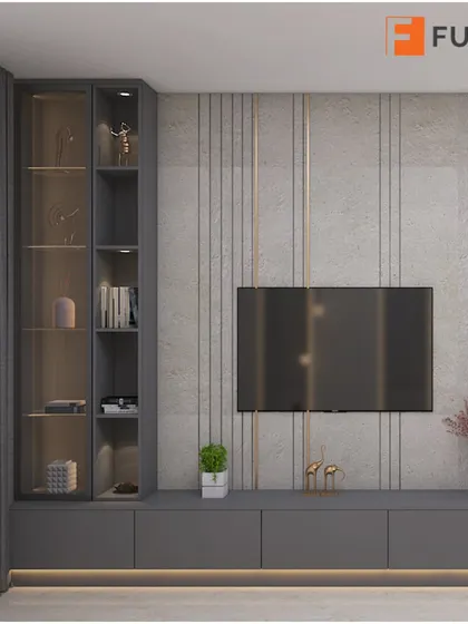 A subtle yet opulent TV unit design. The grey textured wall is accented with gold strips and integrated lighting, creating a sophisticated backdrop for the entertainment center.