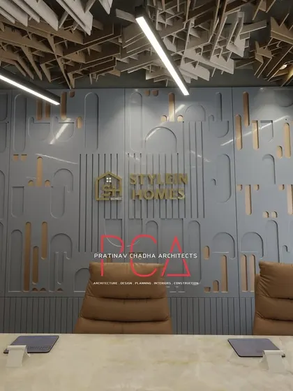 The conference room for the StyleIn Homes office project in New Delhi, featuring a custom-designed acoustic ceiling and a feature wall with the company's branding. This space was designed to be both functional and representative of the client's corporate identity, demonstrating my expertise in commercial interior design.