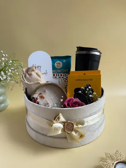 A full view of the luxurious round velvet box for Diwali. This hamper is a perfect example of how we combine tech gadgets, lifestyle products, and festive treats.