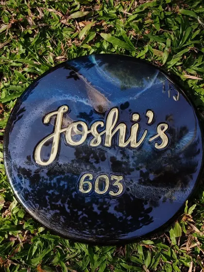 This is the galaxy-themed nameplate I created for a friend, seen here on a natural grass background which contrasts with the deep blues and blacks of the resin.