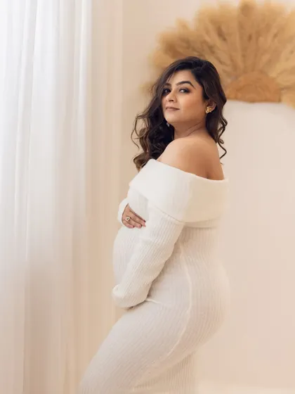 A cozy and chic portrait in a white sweater dress, perfect for a more understated and modern maternity session.