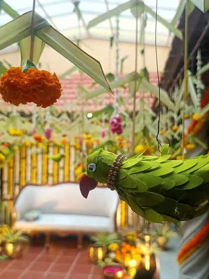 A close-up of a parrot decoration made from leaves, a unique detail for a traditional South Indian wedding.