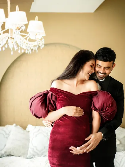 A candid and joyful moment between the couple, their laughter filling the studio as they celebrate their growing family.