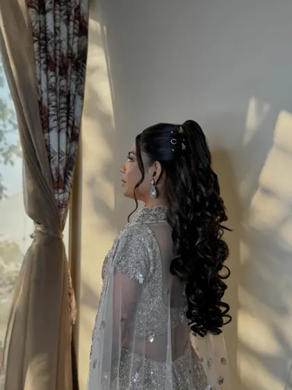 A beautiful curly ponytail for a sangeet night. This hairstyle is both glamorous and practical, keeping the hair off the face for dancing.
