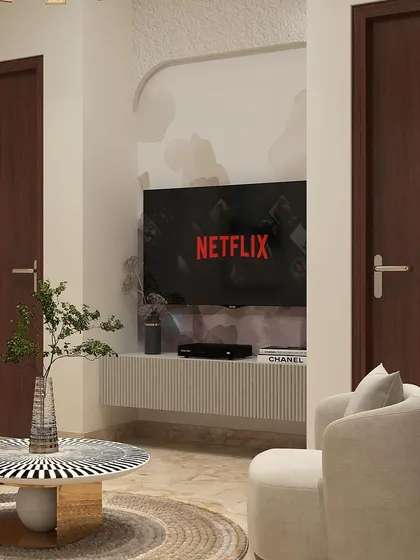 A detail shot of the TV nook in the lounge. The floating console with a fluted finish is set within an arched alcove, creating a subtle architectural feature that frames the entertainment area.