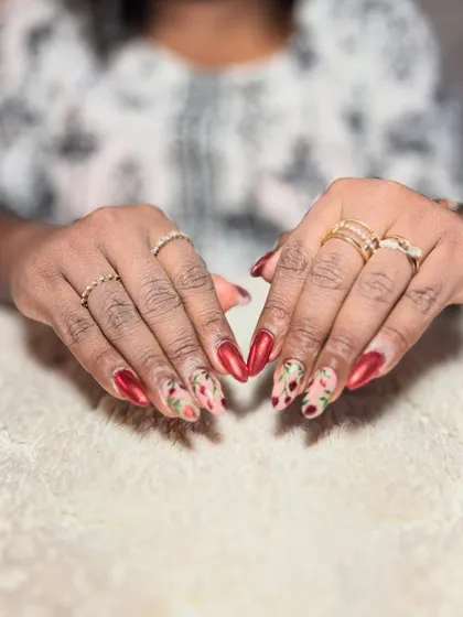 A beautiful red set with floral accent nails. The combination of bold color and delicate pattern is stunning.