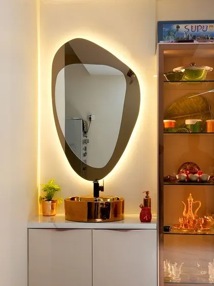 A beautiful detail from Rakesh and Supriya’s home: a modern wash basin with a backlit mirror and an illuminated glass crockery unit, showcasing their collection.