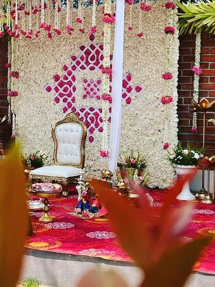A closer look at the beautiful details on the Seemantham stage. The combination of fresh flowers and traditional elements creates a perfect setting.