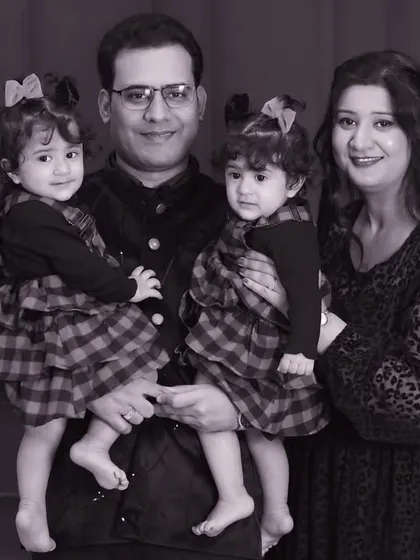 A black and white version of the twin family portrait. Monochrome can add a timeless, artistic quality, focusing purely on expression and emotion.