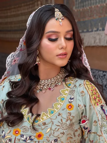 An eyes-closed shot to showcase the beautiful pink and brown eyeshadow, which complements her pastel outfit.