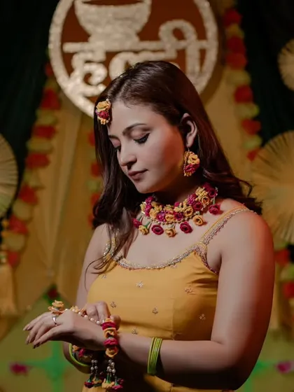 Another stunning shot of Nidhi, focusing on the details of her floral hand jewelry. These detail shots are a must-have for any Haldi album.