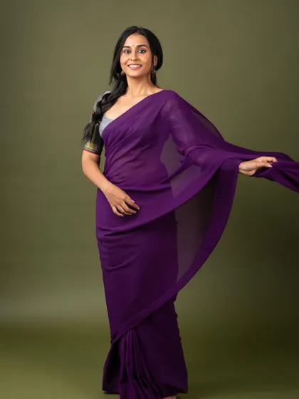 The full view of a simple yet stunning purple saree and custom grey blouse combination.