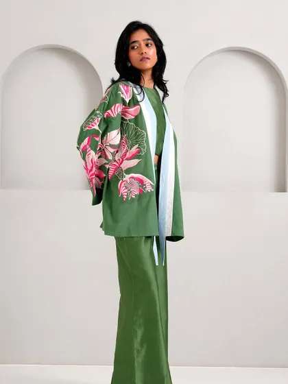 A full view of the green co-ord set from Madder Much, featuring a cropped jacket with floral embroidery and matching trousers.