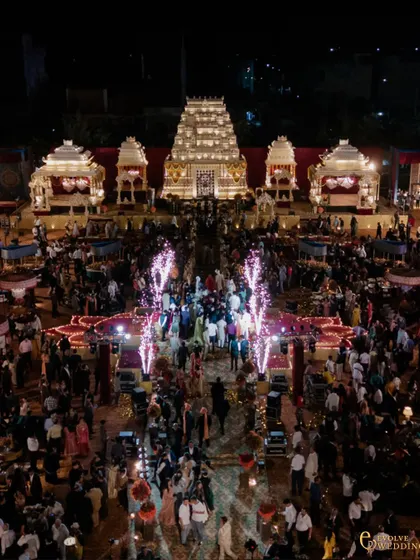 The entire venue comes alive at night, with the illuminated mandap as the focal point. This wide shot captures the energy of the celebration, with thousands of guests enveloped in the world I created.