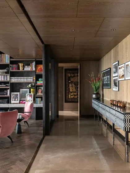 The corridor in the Caitriona apartment, showing the transition from the marble floor to the herringbone wood floor of the living room. The long 'Missoni Console' draws the eye and creates a sense of elegant flow.