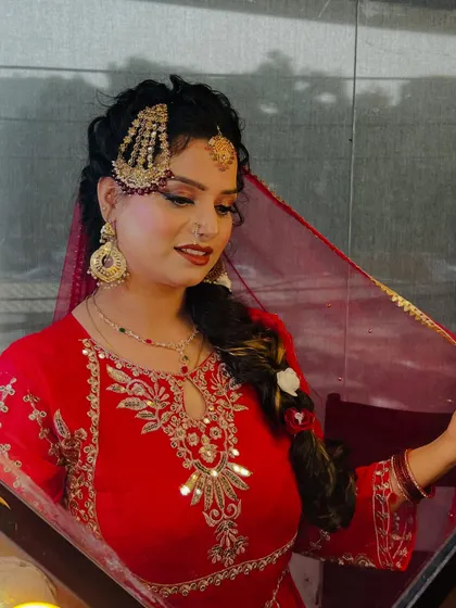 A side profile showcasing the elaborate hair jewelry (passa) and the detailed braid. This highlights my team's skill in traditional hairstyling, which is essential for completing the bridal look.