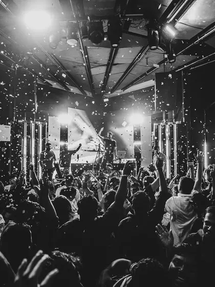A black and white shot of the confetti blast over a packed dance floor. Pure chaos and joy.