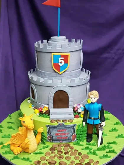 A medieval adventure awaits with this castle and dragon cake. Featuring a brave knight, a friendly dragon, and a two-tier stone castle, it's a fantastic cake for a child with a big imagination.