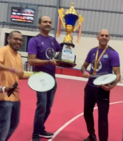 Parents and supporters join in the celebration, holding the Season 1 championship trophy.