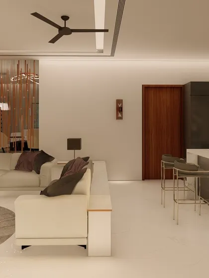 An open-concept living area where the kitchen island doubles as a breakfast bar. The space is defined by a neutral color scheme, clean lines, and subtle metallic accents for a touch of modern elegance.
