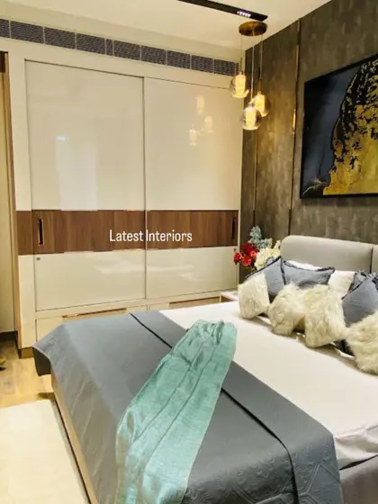This image shows a sliding wardrobe with a clean, two-tone design of high-gloss white and wood finish. The minimalist design provides ample storage while maintaining a sleek look.
