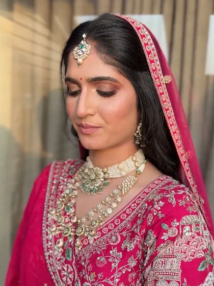 A close-up of the bride's makeup, with soft pink tones on the eyes and cheeks for a romantic feel.