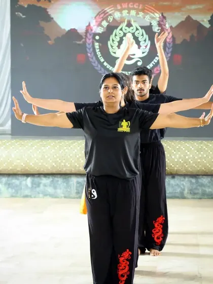 Leading my students in a synchronized arm movement form. This practice, known as Taolu, is a cornerstone of Wushu training, combining fluid motions with sharp, powerful strikes.