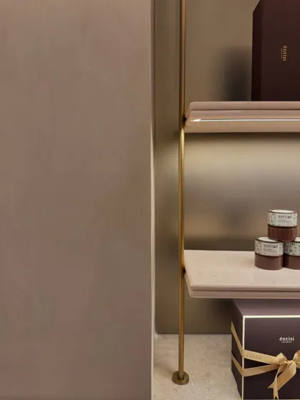 This detail shot of the shelving at Entisi highlights the clean joinery between the brass supports and the marble shelves. Such subtle details are what contribute to the overall feeling of refined minimalism in the space.
