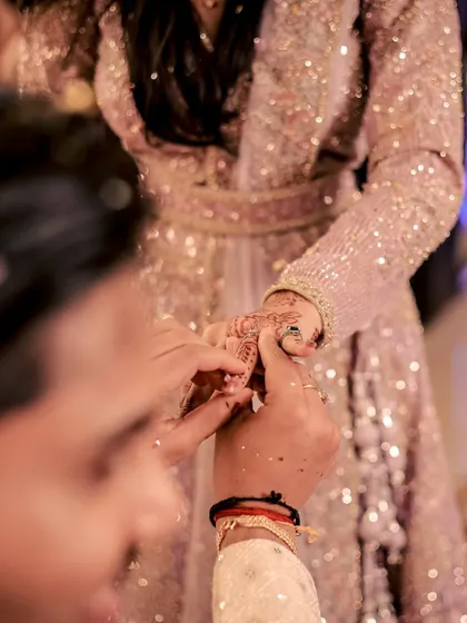 A detailed shot focusing on the ring exchange during an engagement ceremony, a key moment of the event.