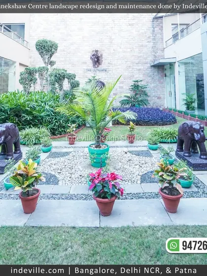 A formal garden layout at Manekshaw Centre, with symmetrical planters, stone elephant statues, and pebble beds. This demonstrates my ability to execute classic and formal landscape designs.
