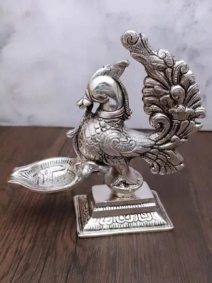 A front view of the antique German silver peacock diya, a piece that truly stands out for its craftsmanship.