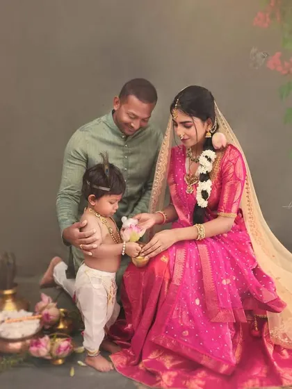 A complete family portrait from a Krishna-themed session. The father, mother, and child come together in a beautifully composed frame that tells a story of love, faith, and family.