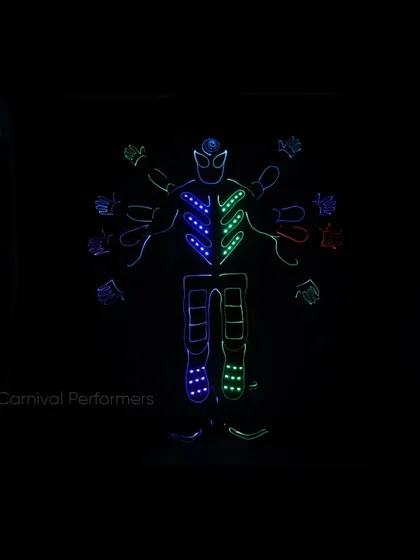 We create illusions with light. This special effect shot shows a Tron performer with multiple glowing arms, a glimpse into our neon fantasy.
