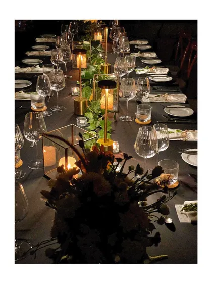 Another view of the modern, minimalist tablescape, showing how lighting and simple greenery can create a powerful effect.