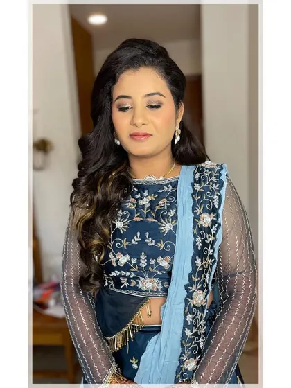 Glowing skin is always the goal. For her sangeet night, I created a luminous base with soft, smokey eyes to make her feel absolutely radiant in her beautiful blue lehenga.